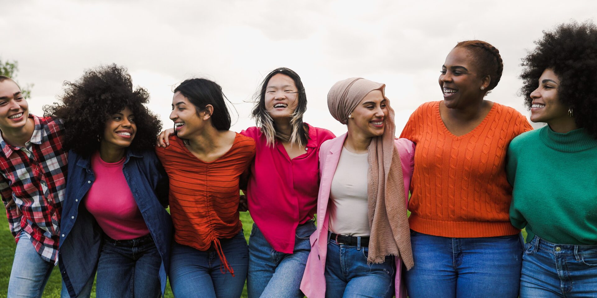 a group of women linking arms